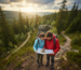 A couple using a map and compass on a trail, representing the guidance provided by couples therapy for trust issues.